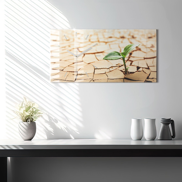 Horloge rectangulaire horizontale Une plante dans un sol asséché