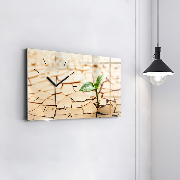 Horloge rectangulaire horizontale Une plante dans un sol asséché