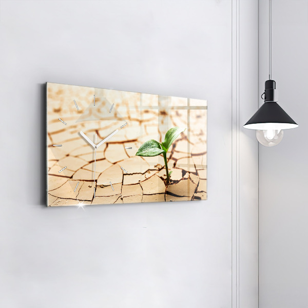 Horloge rectangulaire horizontale Une plante dans un sol asséché