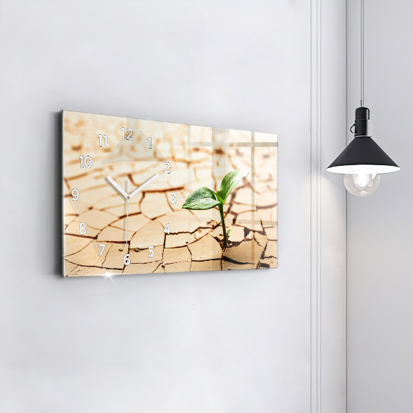 Horloge rectangulaire horizontale Une plante dans un sol asséché