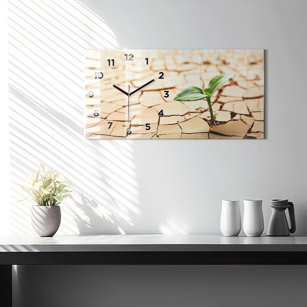 Horloge rectangulaire horizontale Une plante dans un sol asséché