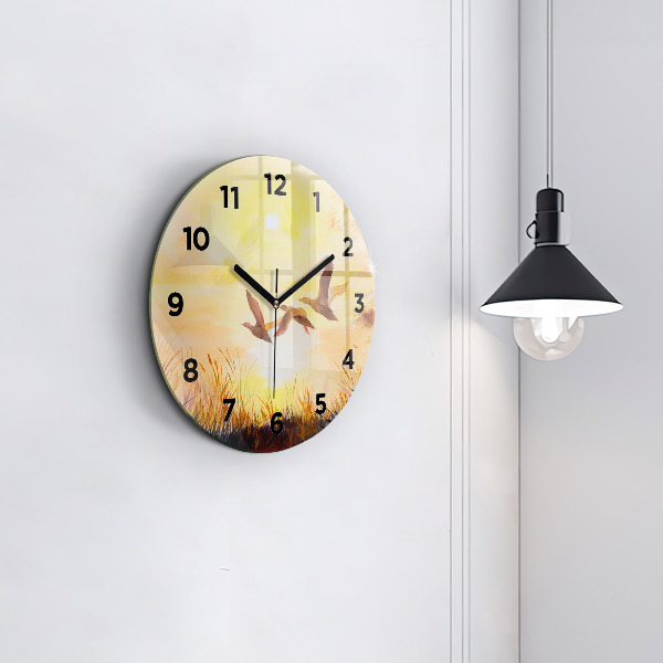 Pendule murale ronde Grues au coucher du soleil