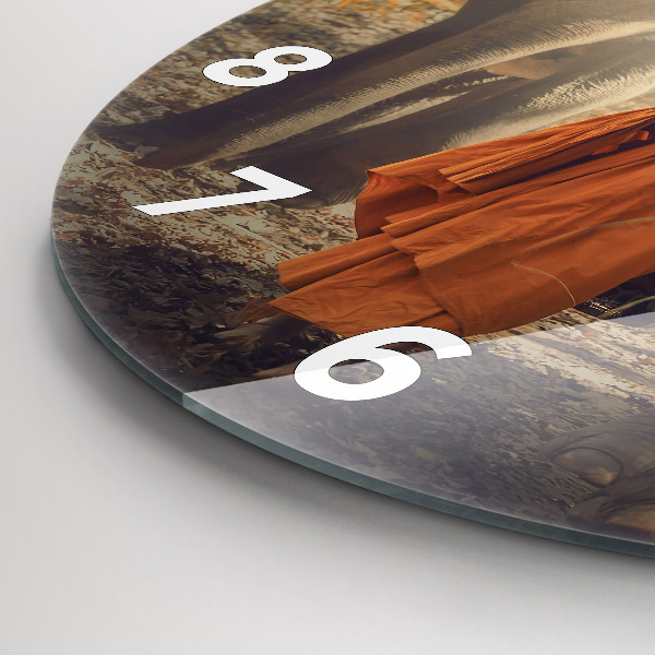 Horloge ronde Moine conduisant des éléphants