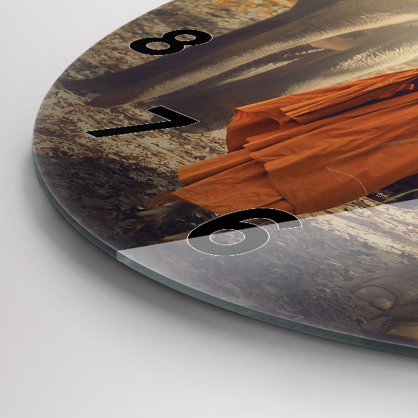 Horloge ronde Moine conduisant des éléphants